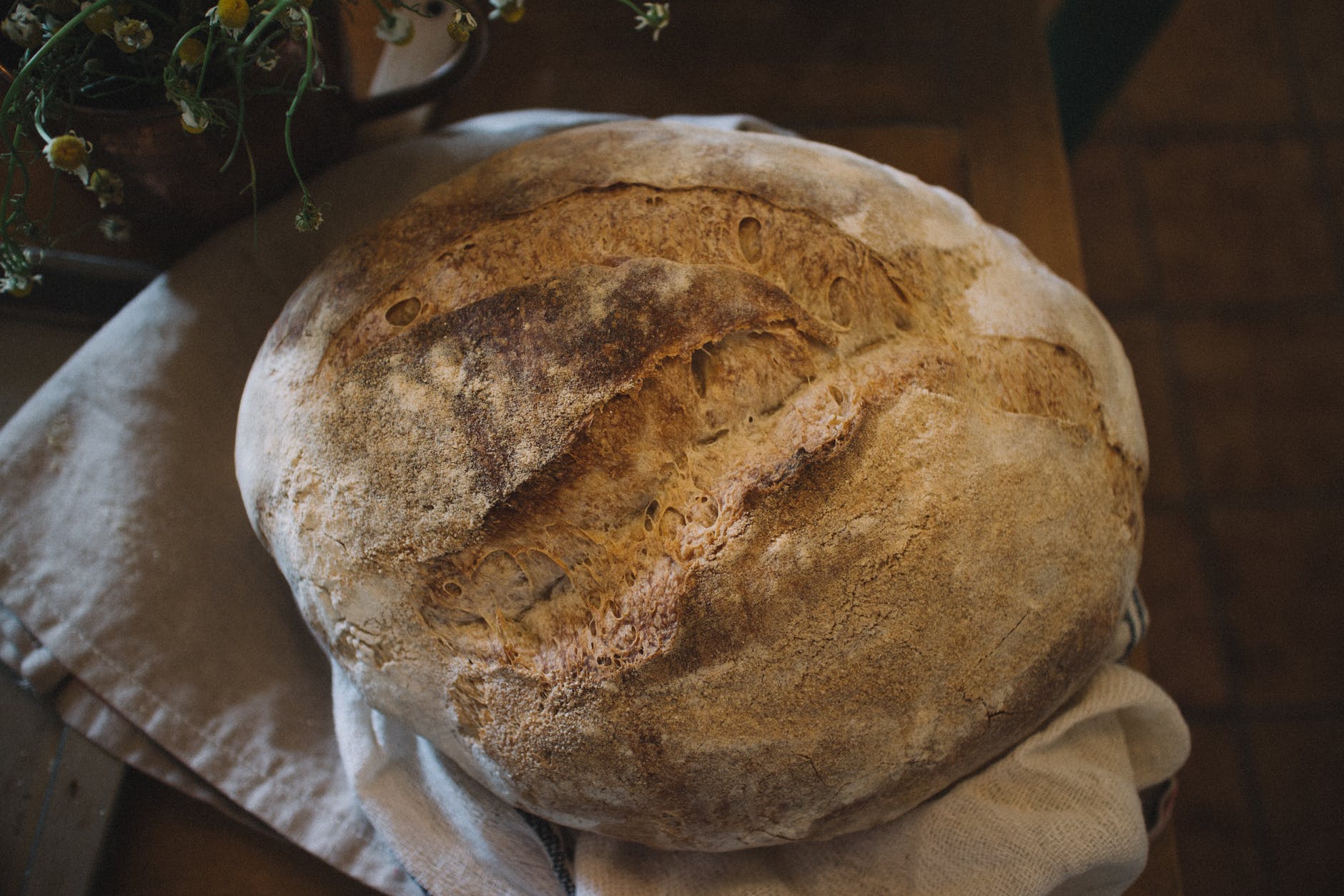 Photo of a homemade loaf of sourdough bread by Monserrat Soldu00fa on Pexels.com